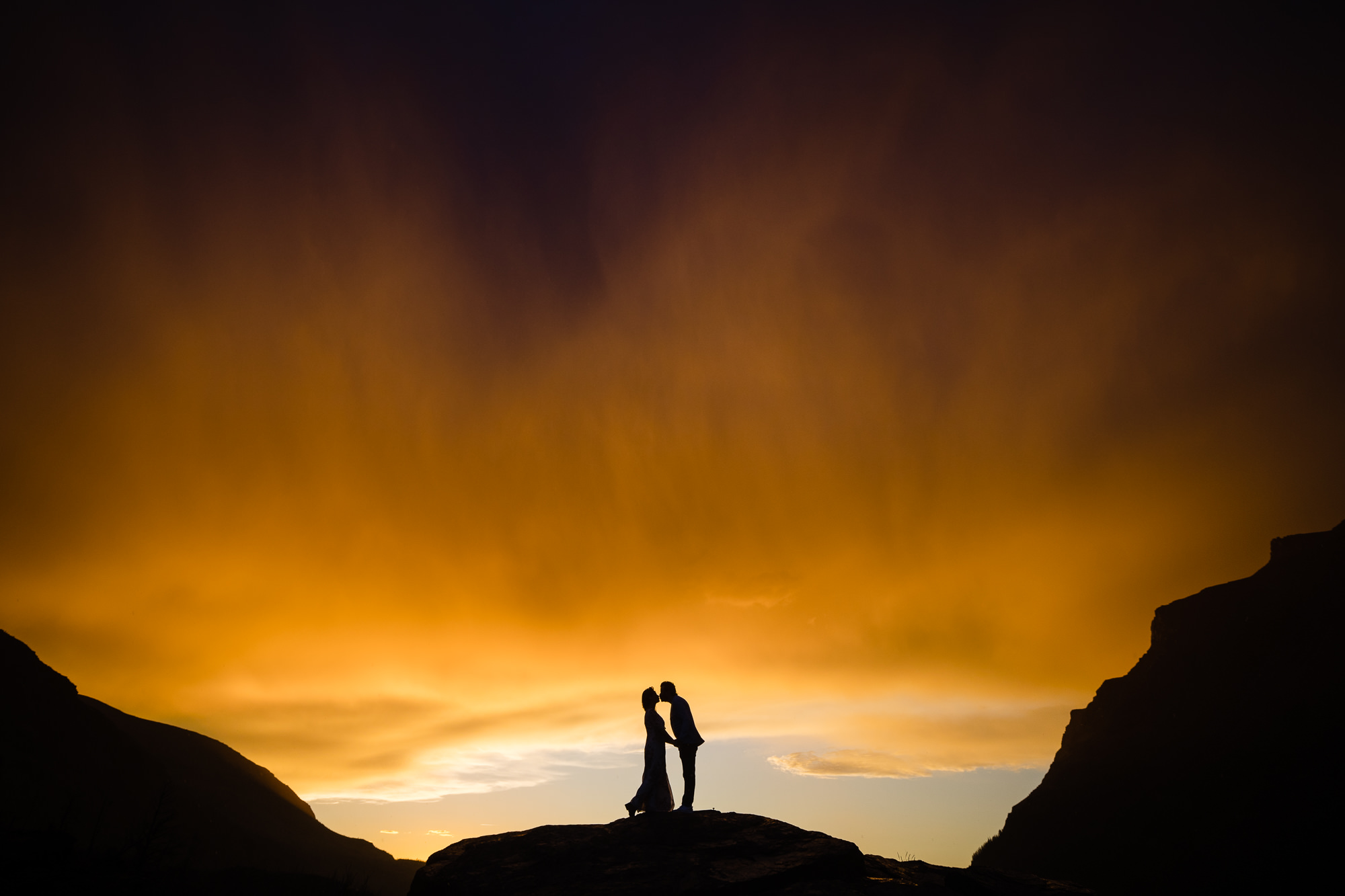 Silhouette of couple against dramatic orange skies - photo by Montana wedding photographer David Clumpner Silhouette of couple against dramatic orange skies - photo by Montana wedding photographer David Clumpner
