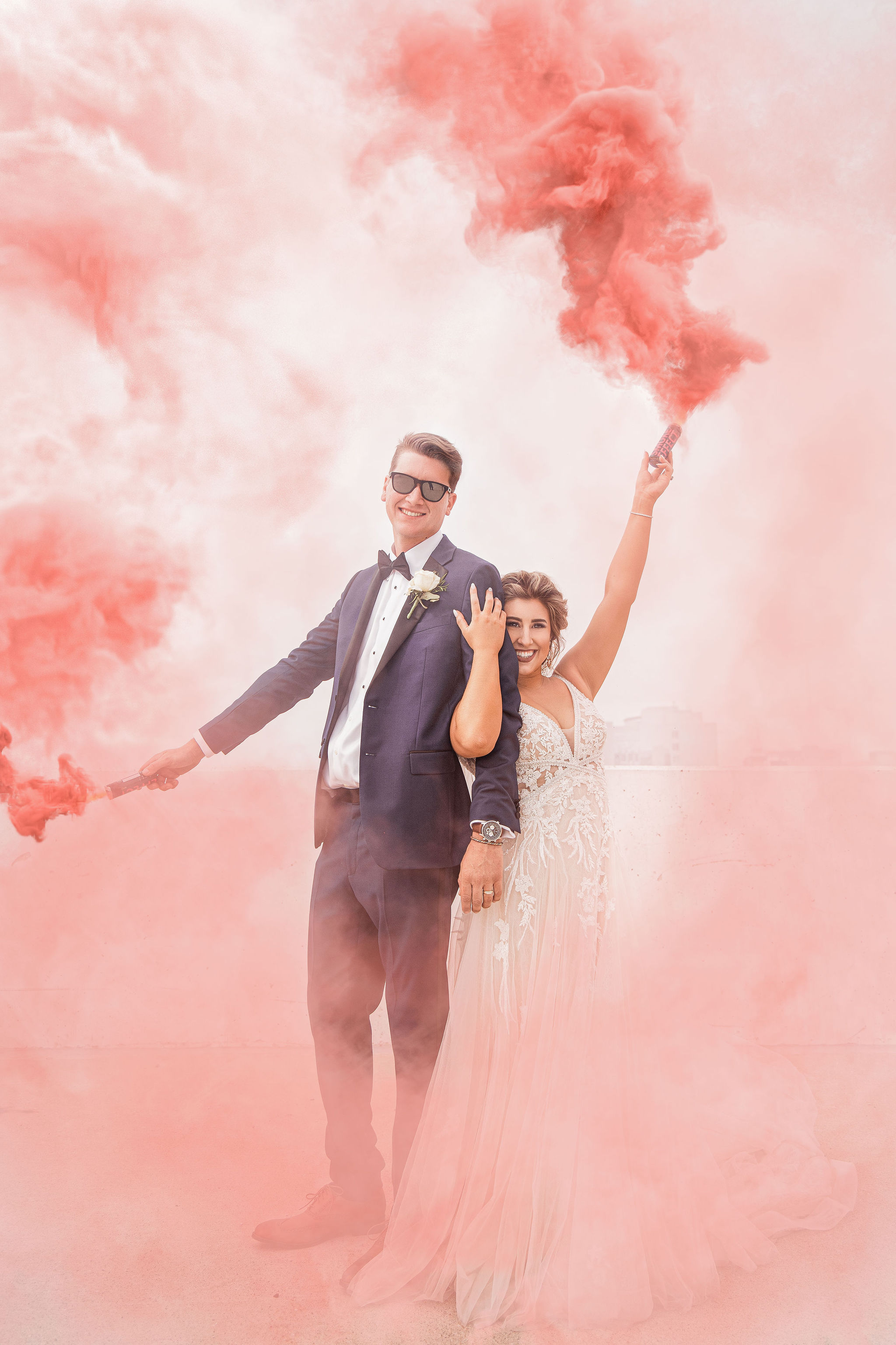 Couple pose in pink smoke, photo by Chrystin Melanie Photography