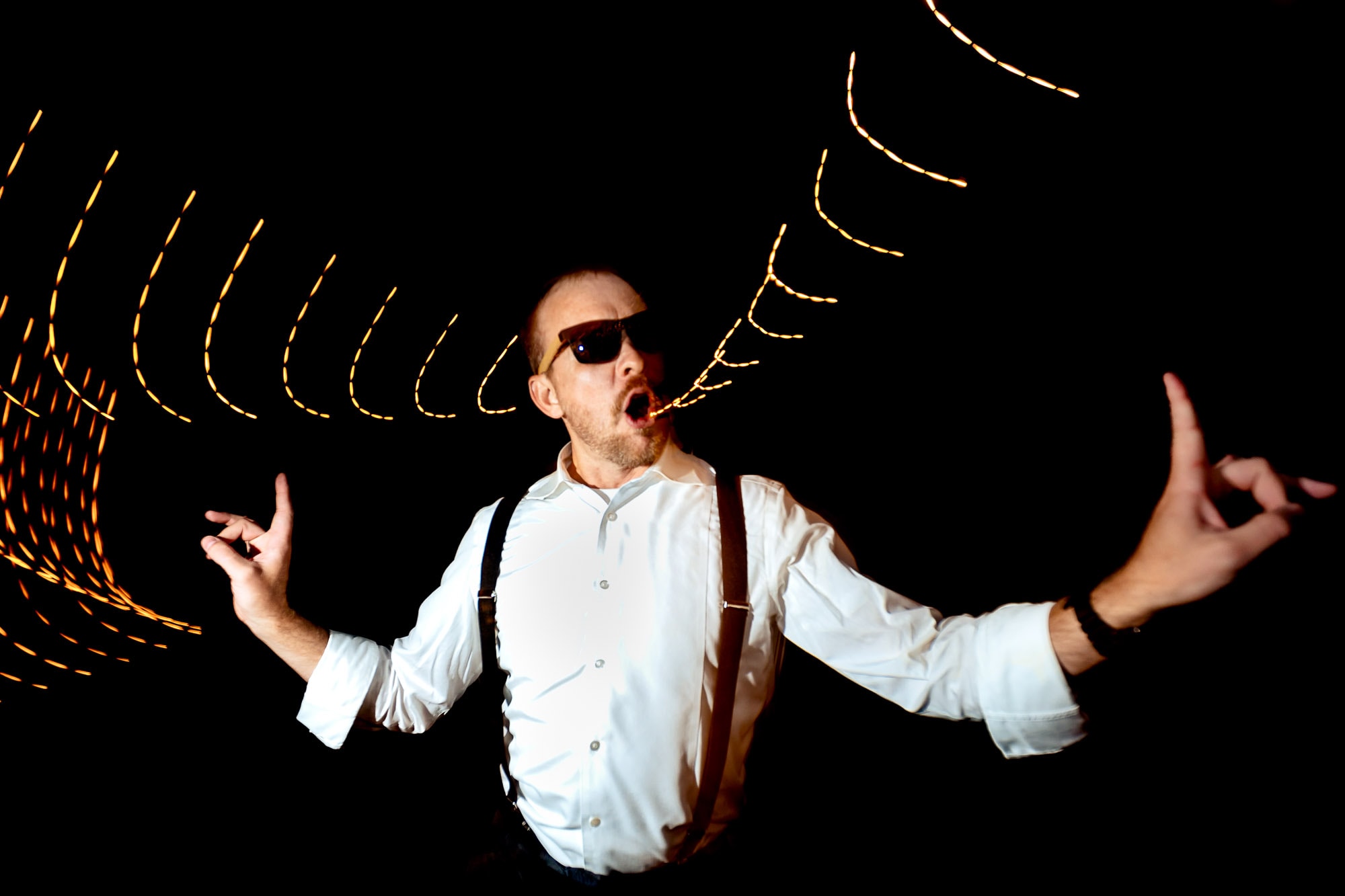 Award-winner-man wearing sunglasses dancing with fun lights - photo by JOS & TREE