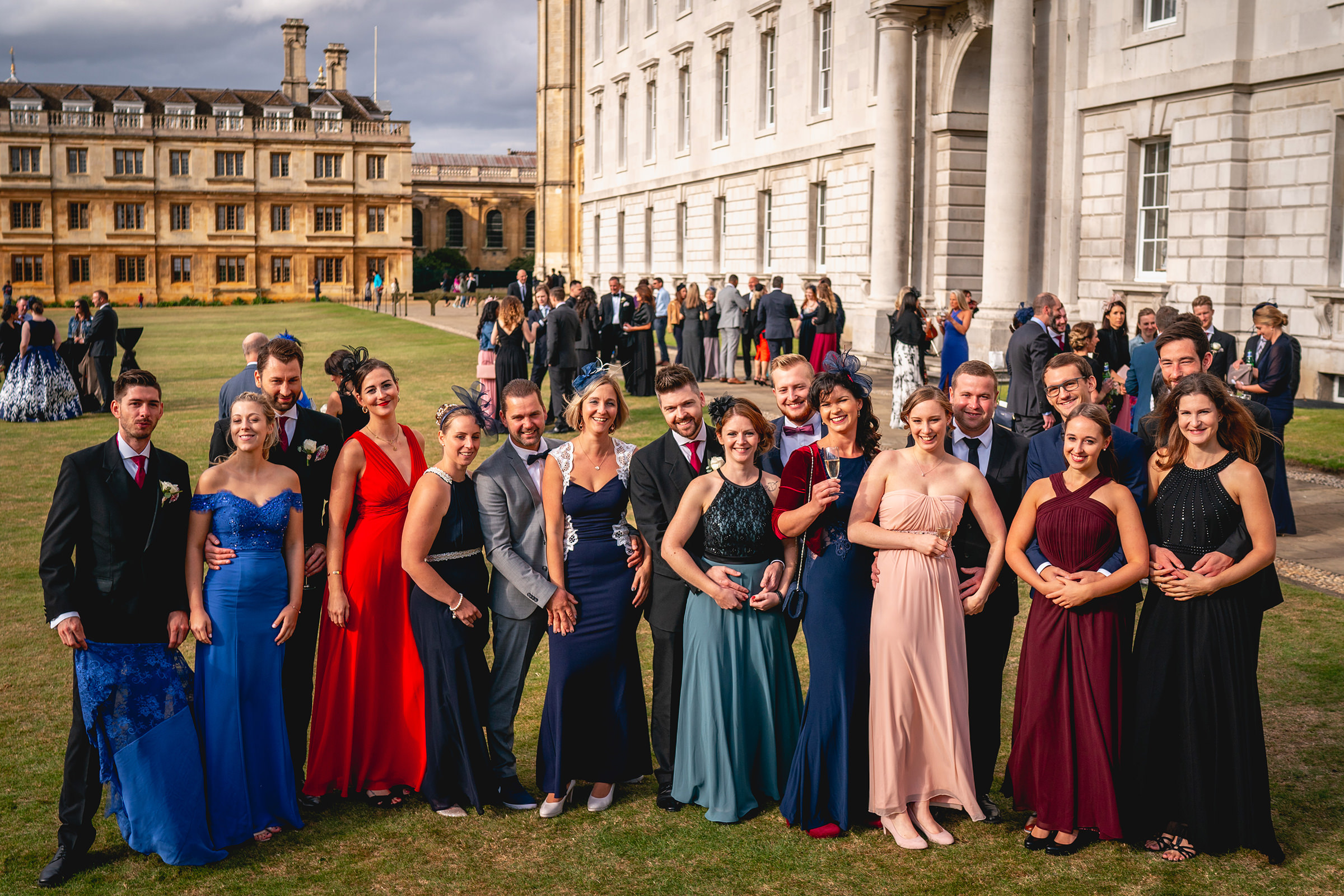 Colorful group shot with other guests in background, by UK wedding photographer Ben Minnaar Photography Colorful group shot with other guests in background, by UK wedding photographer Ben Minnaar Photography