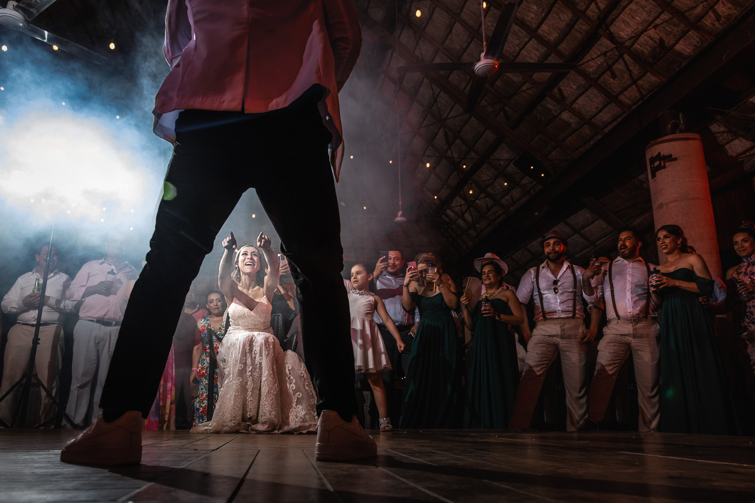 Award winner, Bride pointing at groom during garter toss - M.E. Photo & Films, Cancun