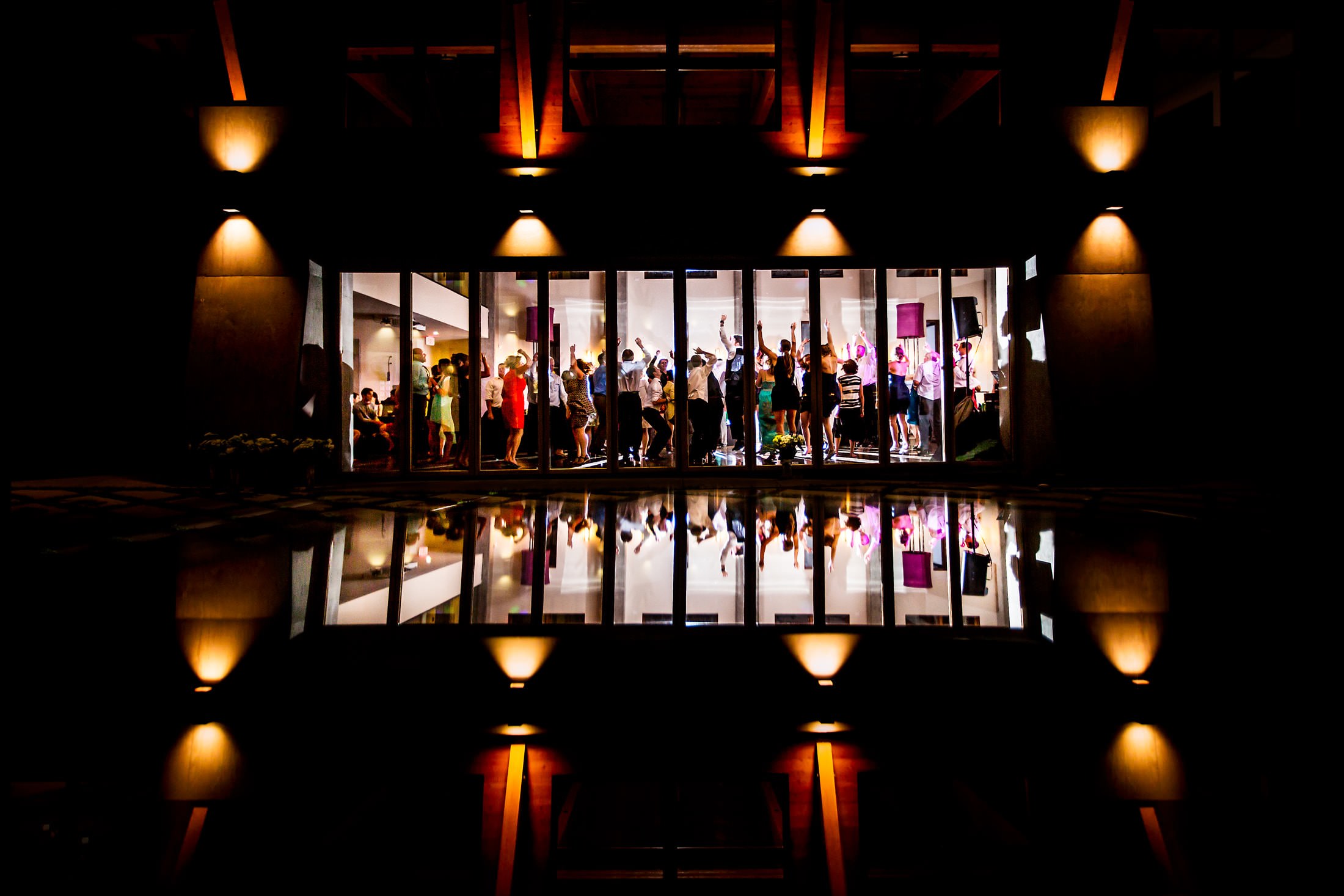 Award winner, party seen through glass windows, Two Mann Studios, Calgary, Canada