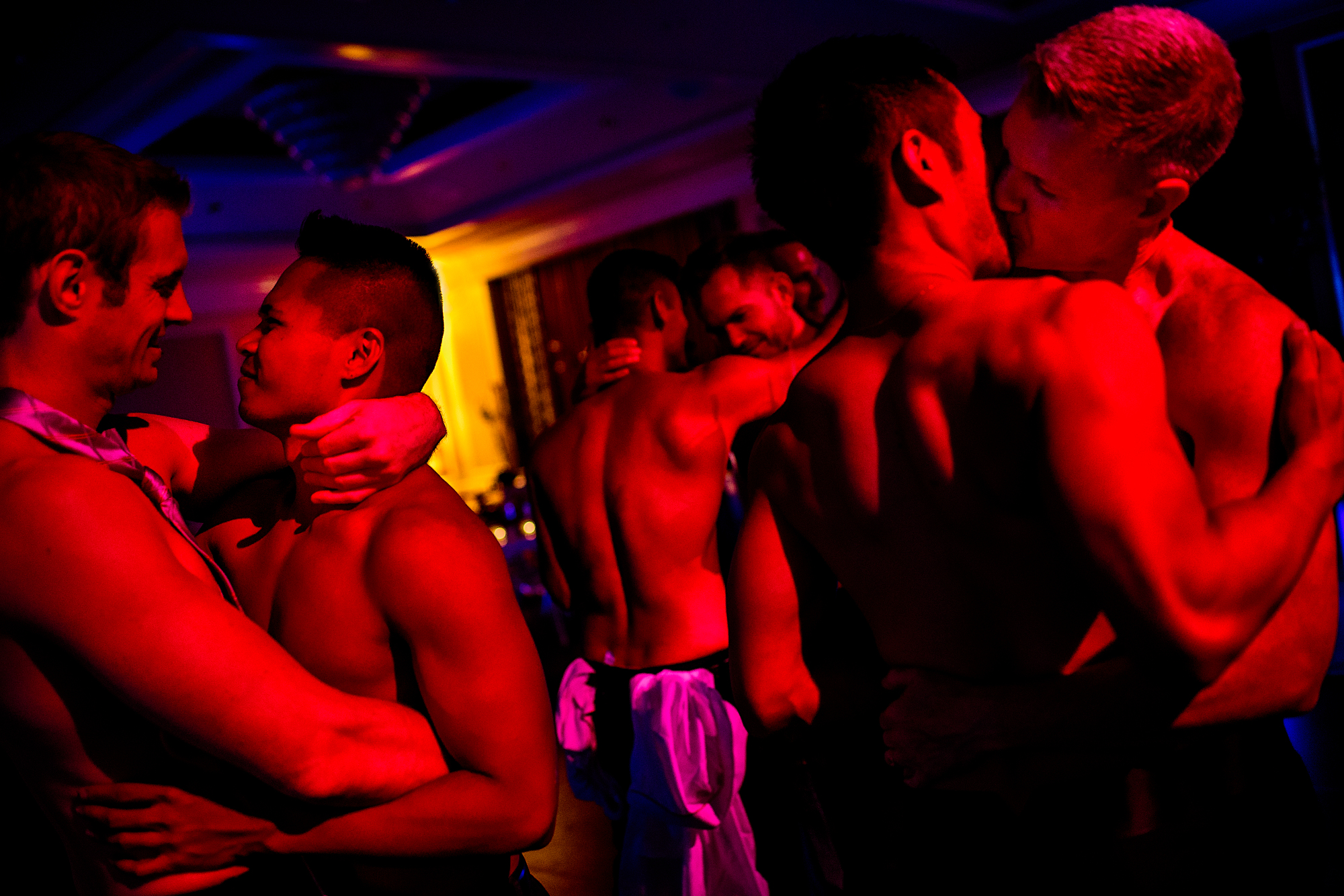Men in gay club embracing - photo by Chrisman Studios
