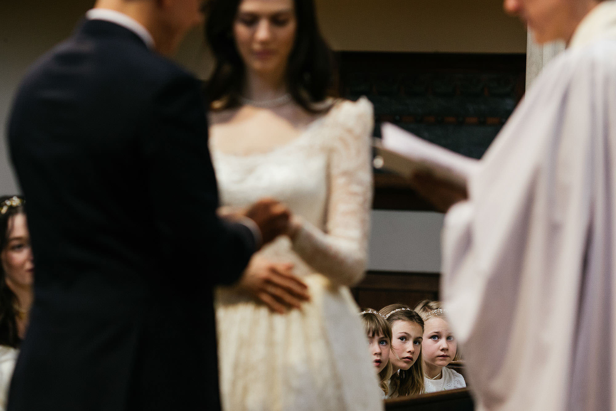 little girls looking on during ceremony, photo by Lyndsey Goddard Photography
