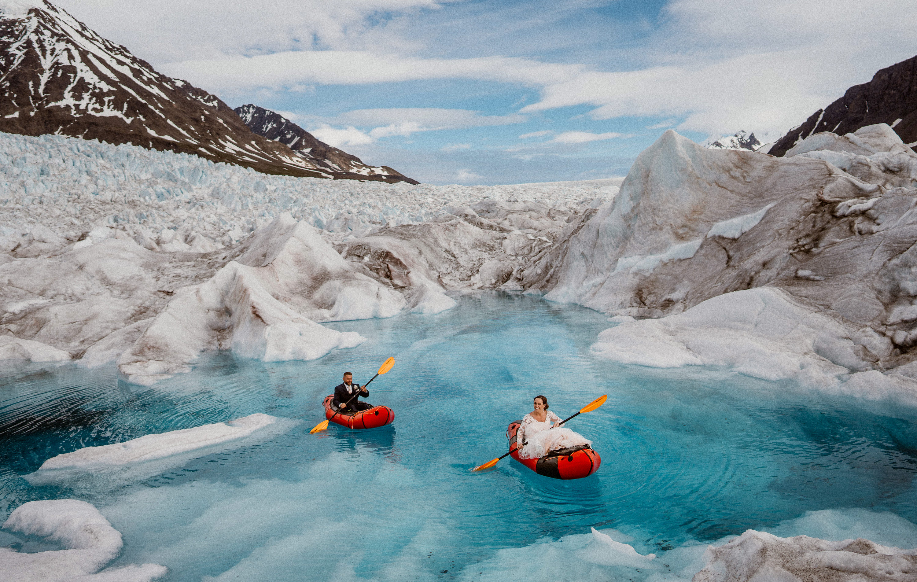 Best adventure wedding photo, couple kayaking in glacier lake by Colorado elopement photographer Adventure Instead