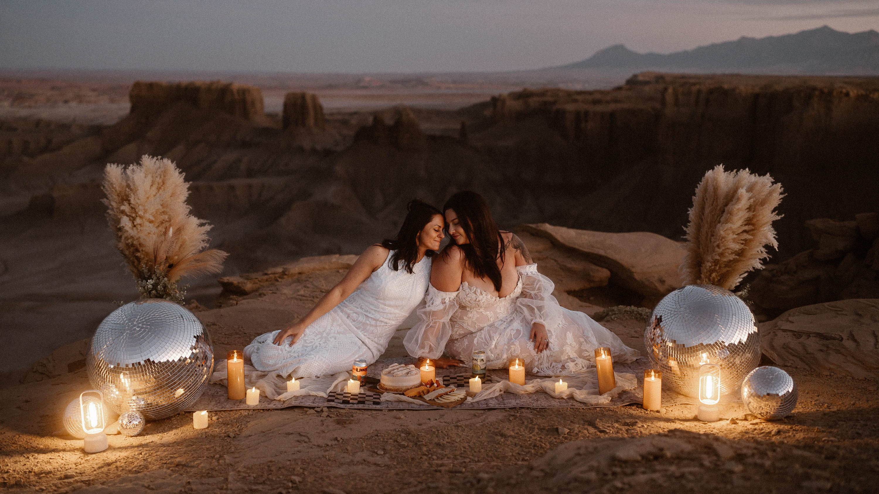 Brides in candlelit canyon scene - photo by Colorado elopement photographer Adventure Instead