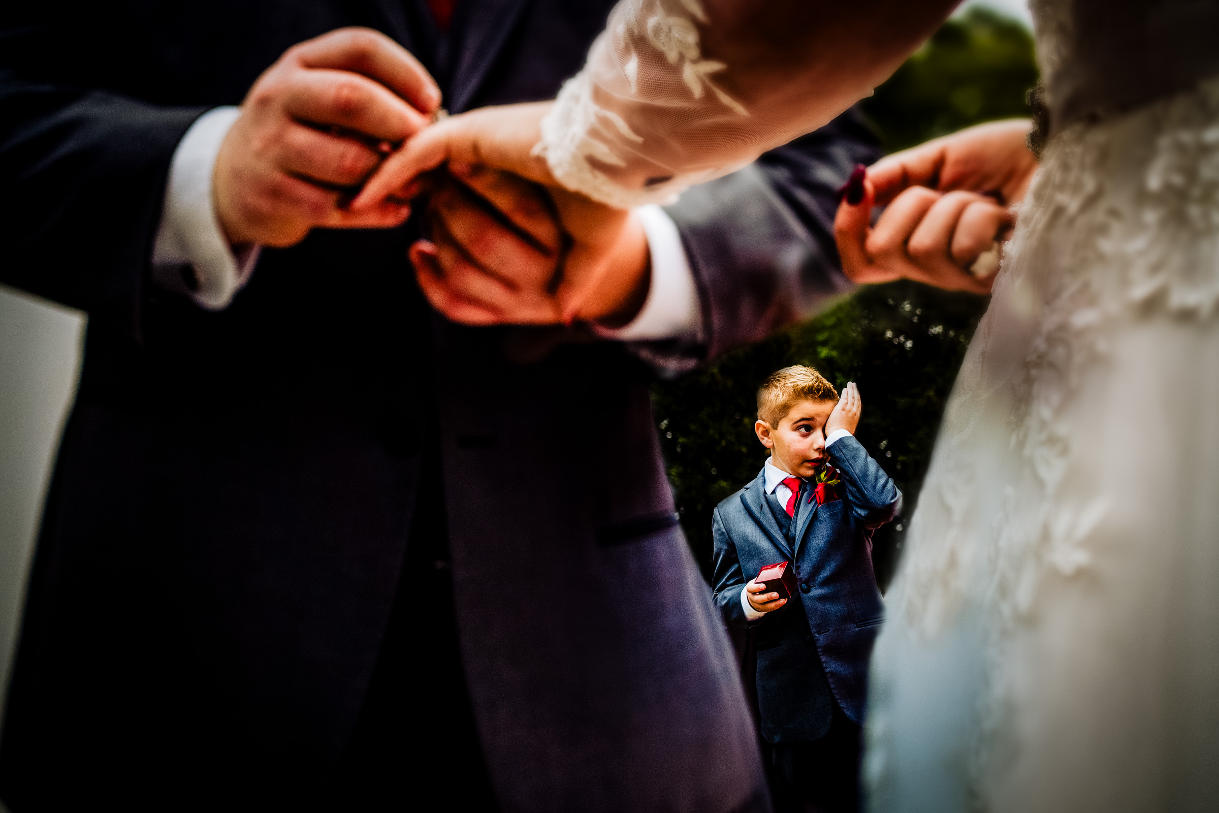 little boy crying in background framed by bride and groom- photo by Joshua Grasso Photography-Georgia wedding photographer little boy crying in background framed by bride and groom- photo by Joshua Grasso Photography-Georgia wedding photographer
