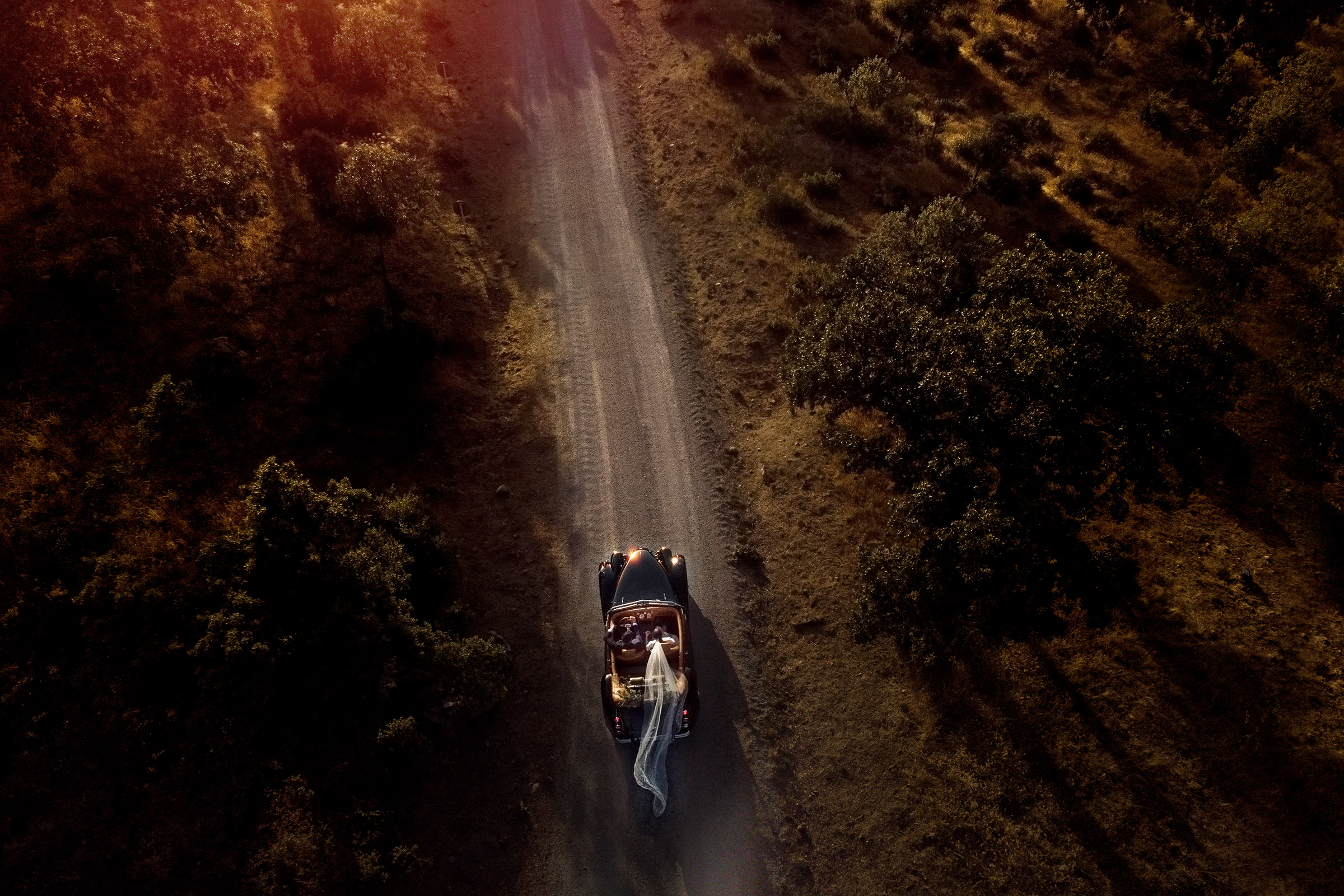 Aerial drone shot of convertible with bride and groom - photo by Jorge Sastre, Spain and destination wedding photographer Aerial drone shot of convertible with bride and groom - photo by Jorge Sastre, Spain and destination wedding photographer