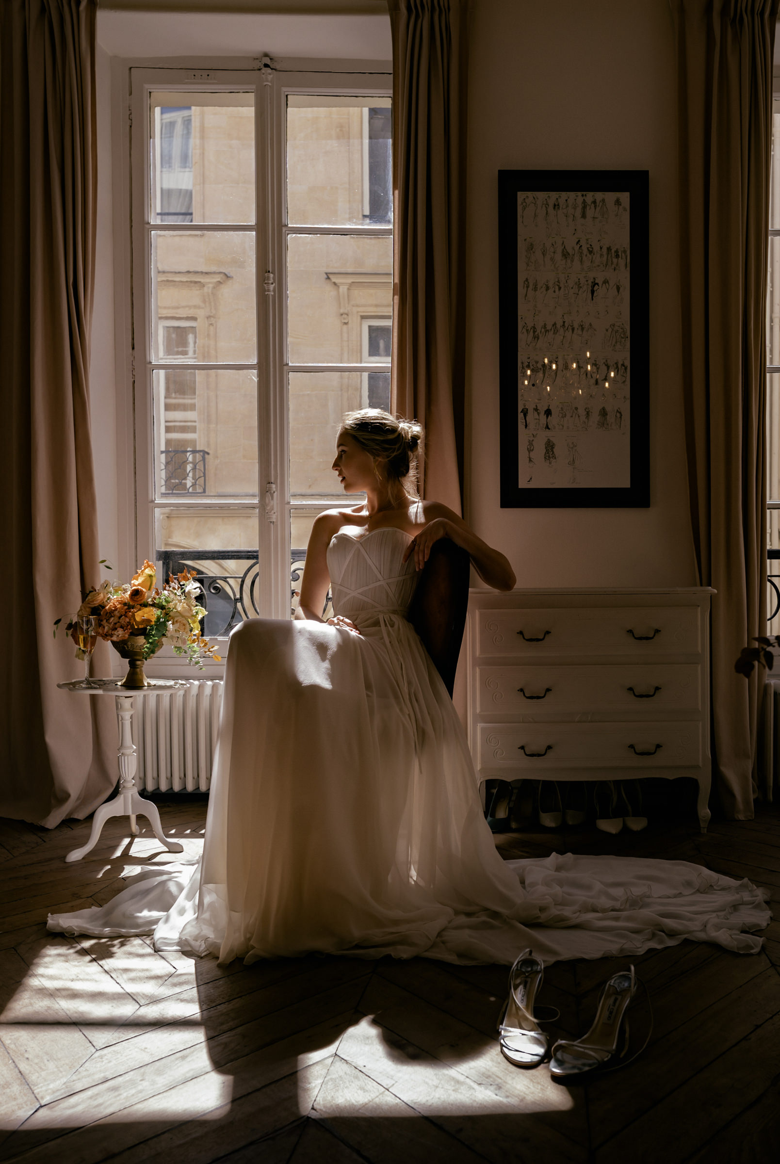 Bride sitting by window - photo by Bagrada Photos