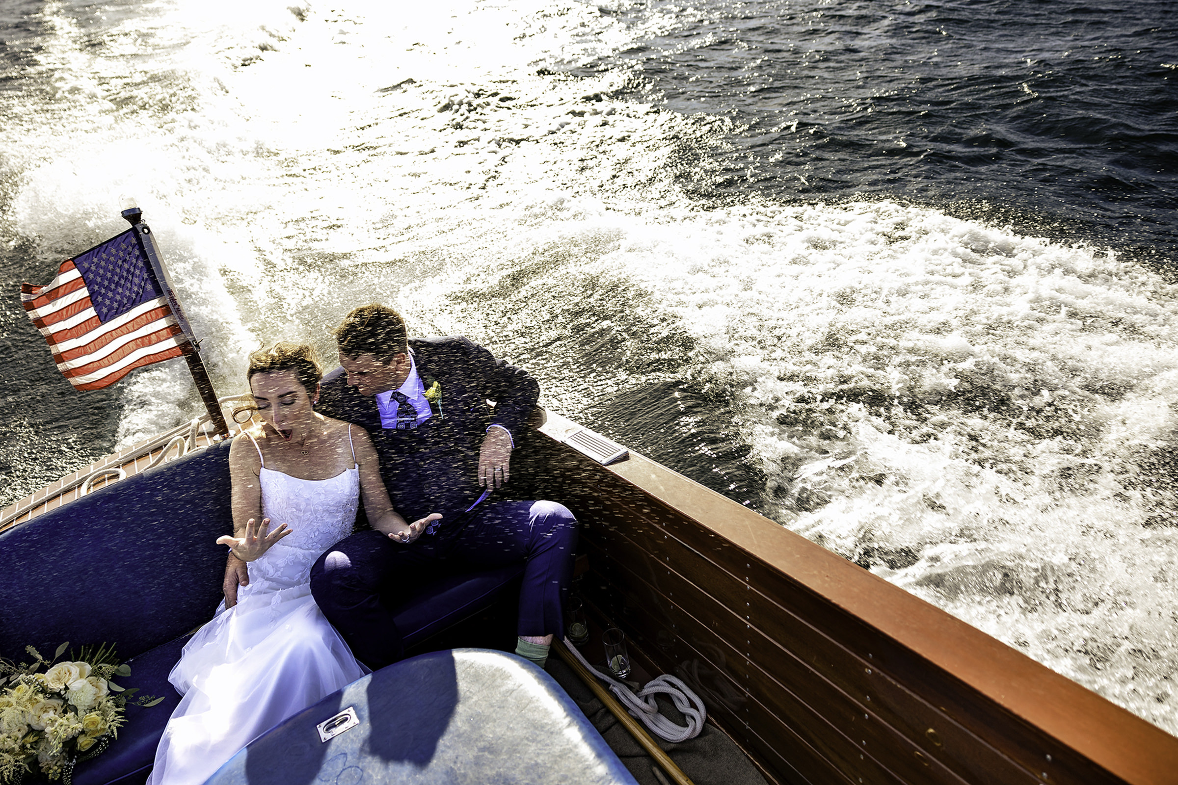 Bride and groom splashed during boat ride - photo by Garrentee Photography-Vermont wedding photographer
