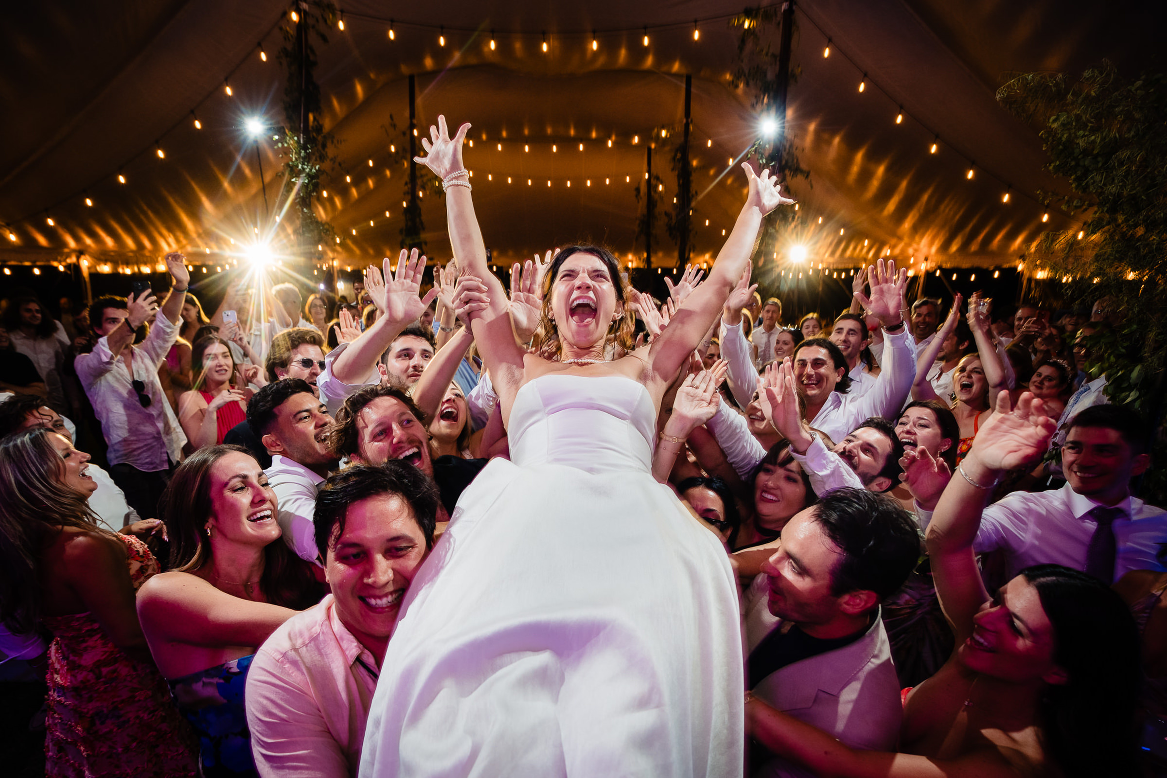 Bride crowd surfing on guests - photo by Montana wedding photographer David Clumpner