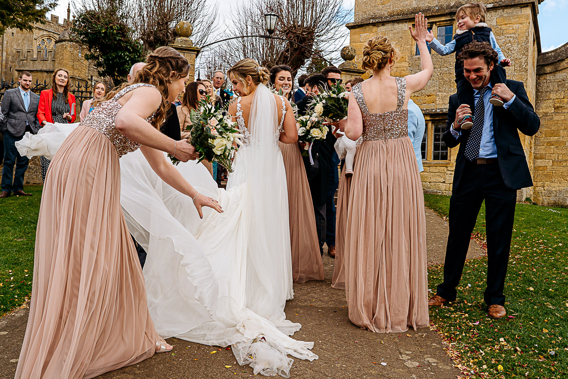 Complex composition moment of bride and guests interacting - photo by Reportage Studios 
