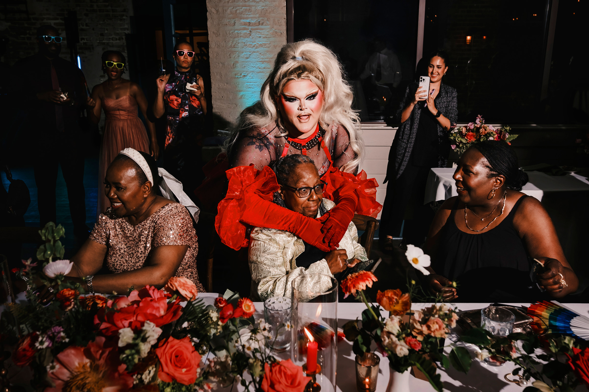 Drag queen hugging shocked guest- photo by Chrisman Studios