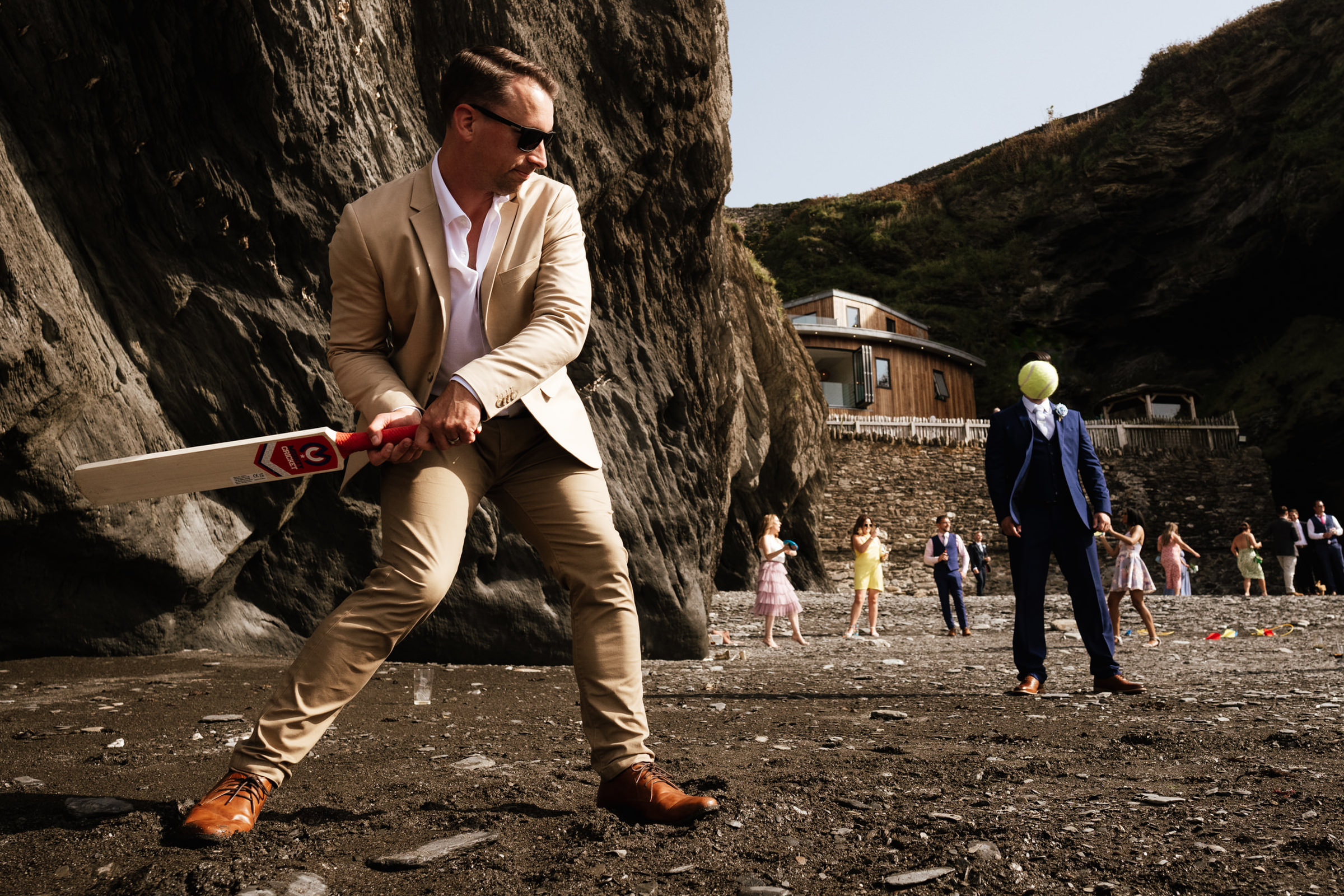 Groom playing cricket with timely ball placement- photo by Robin Goodlad Photography