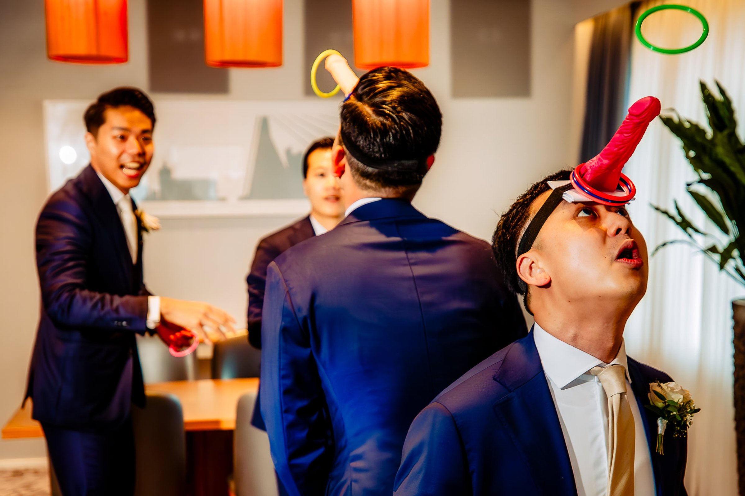 Groomsmen playing funny groom games - photo by Netherlands documentary wedding photographer Eppel Photography