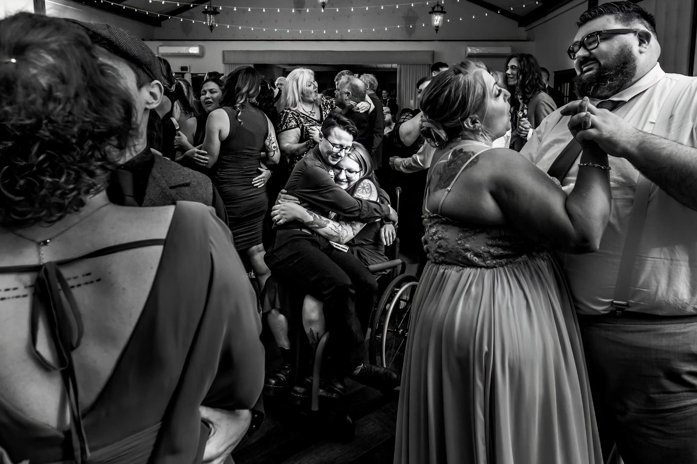 Guests in wheelchair hugging - photo by New Jersey wedding photographer Daniel Nydick Photography