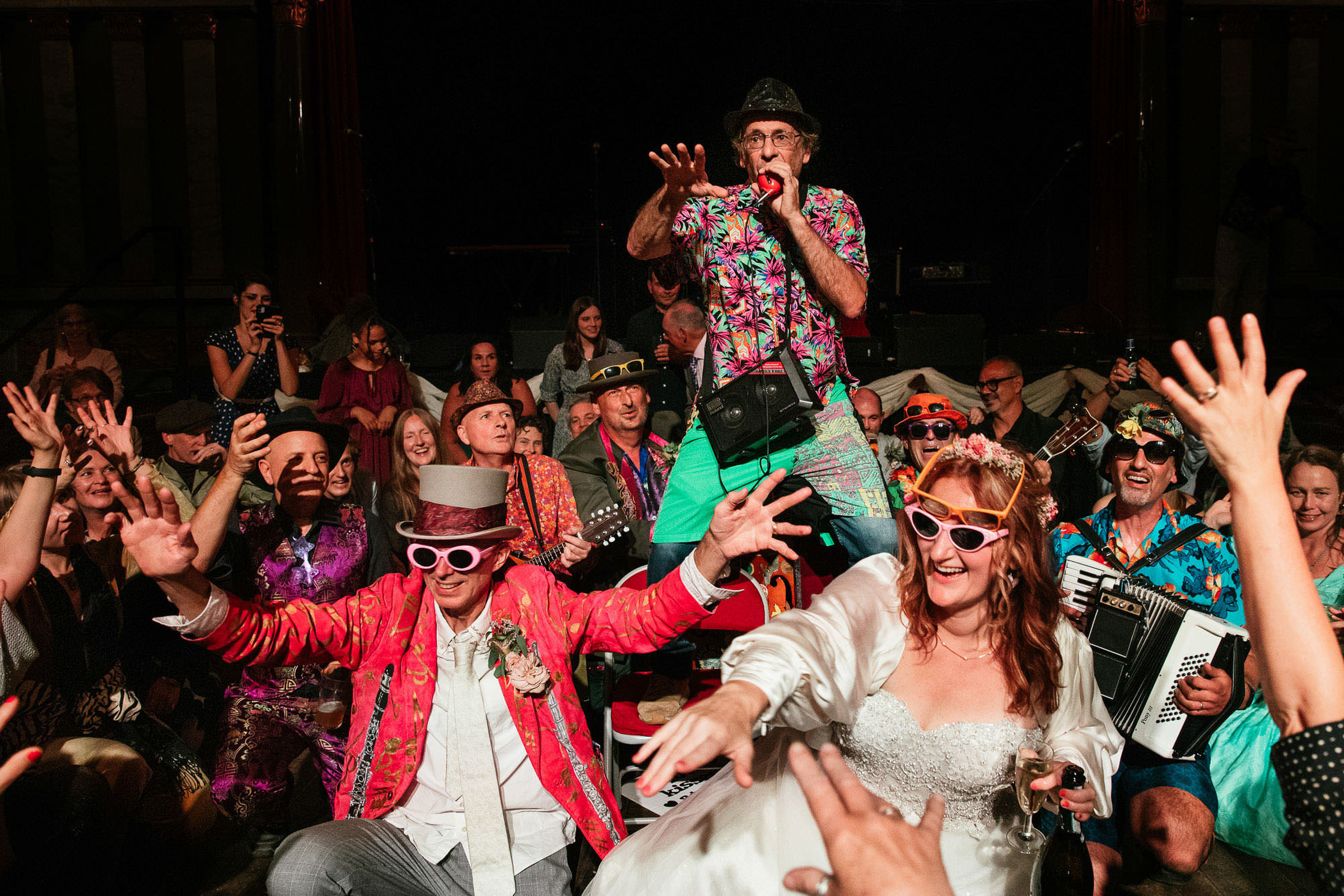 Party photo of bride and groom with guests - photo by Lyndsey Goddard Photography