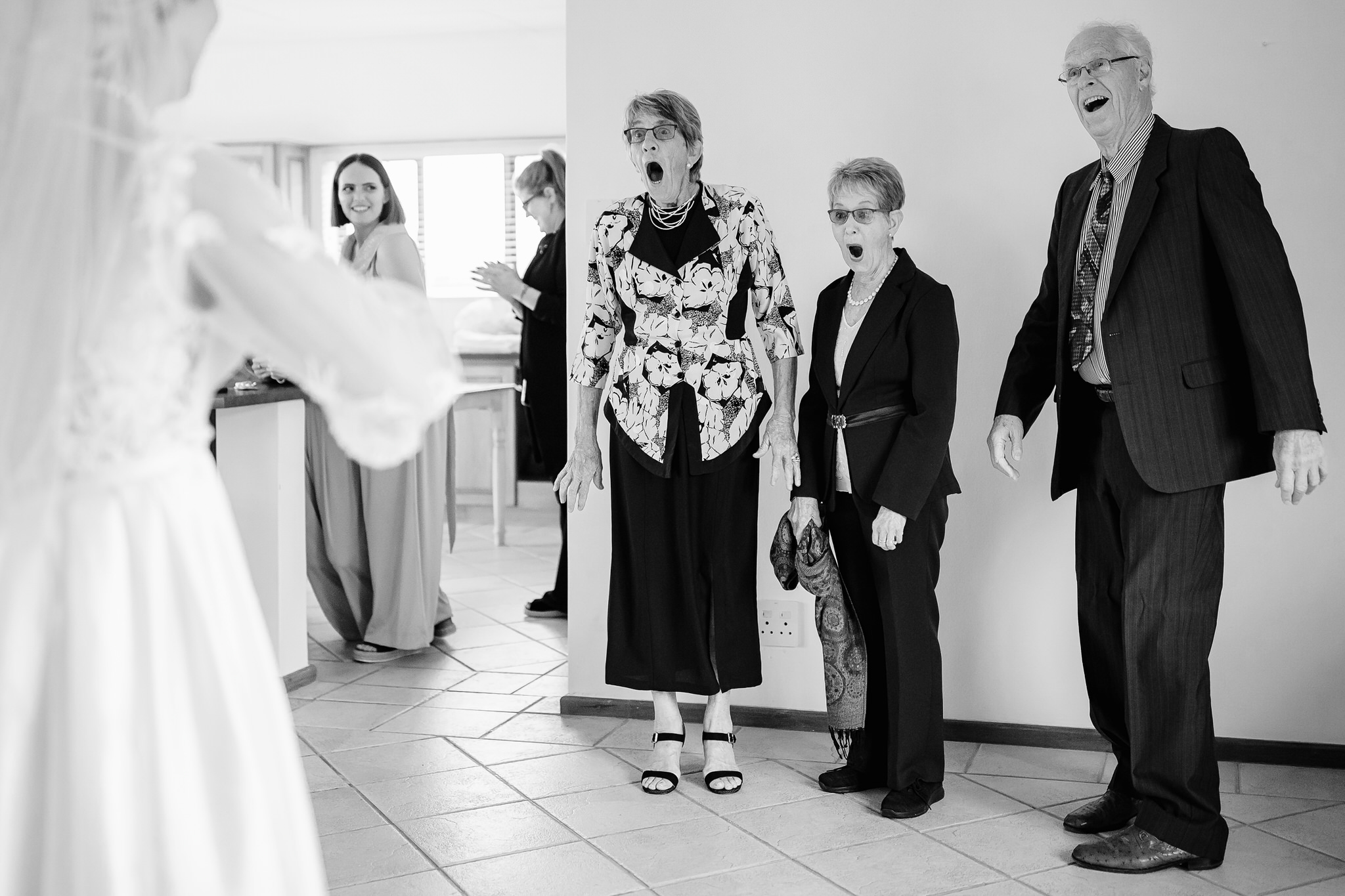 Surprised family during bride reveal - photo by Ruan Redelinghuys Photography