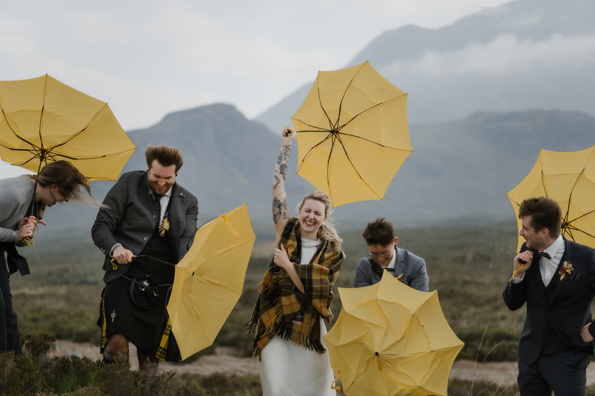 Yellow umbrellas blowing in the wind - photo by Raini Rowell Photography