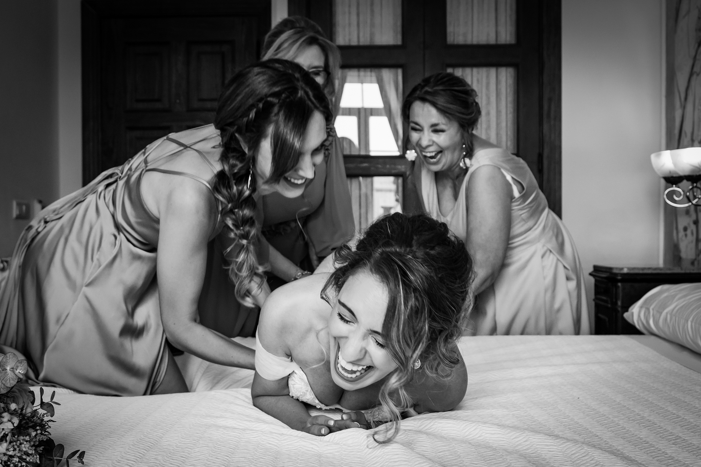 Bridesmaids tickling the bride, photo by Torres & Garcia