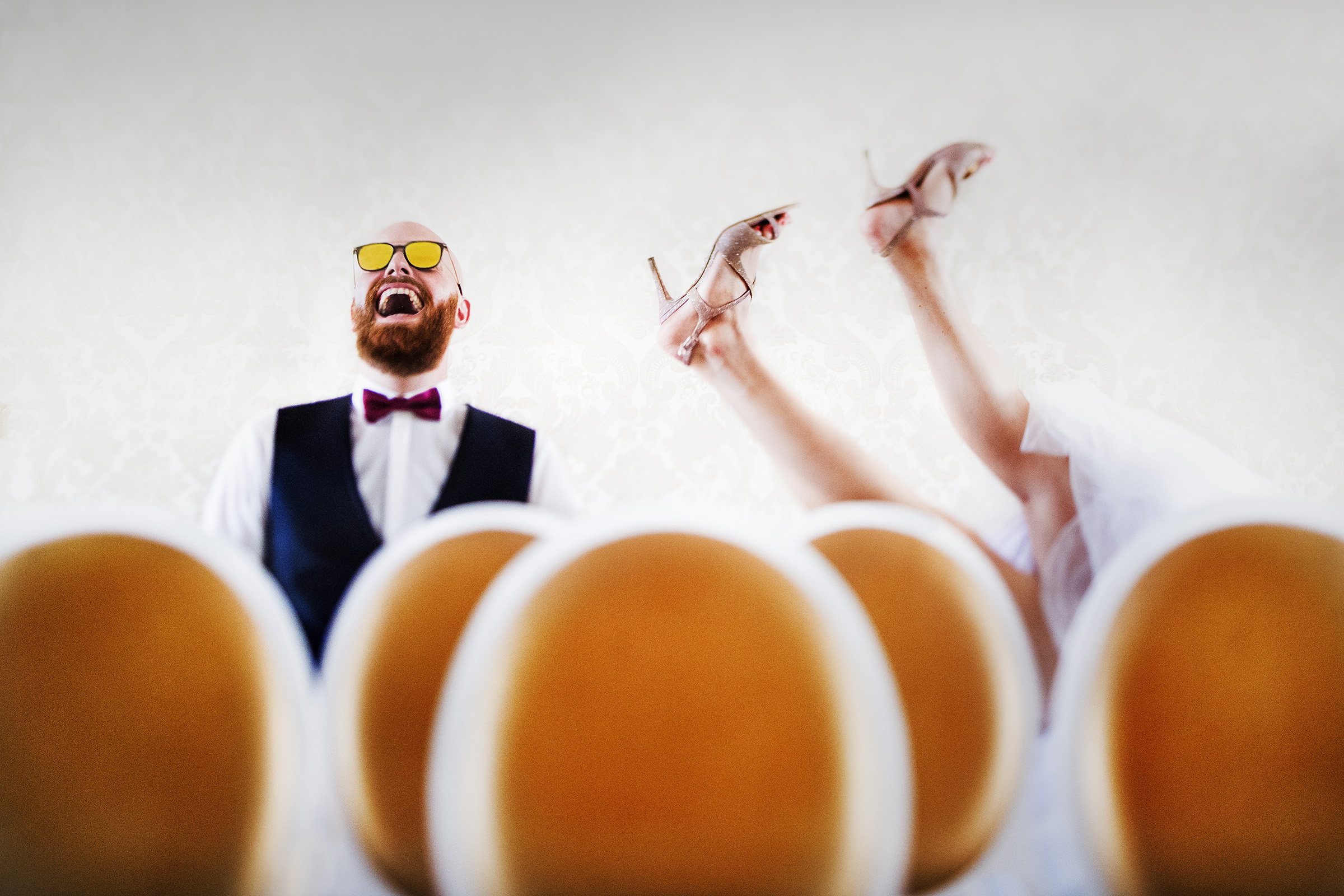 groom laughs in sunglasses with brides legs in air -image by Barcelona Spain wedding photographer Victor Lax Photography groom laughs in sunglasses with brides legs in air -image by Barcelona Spain wedding photographer Victor Lax Photography