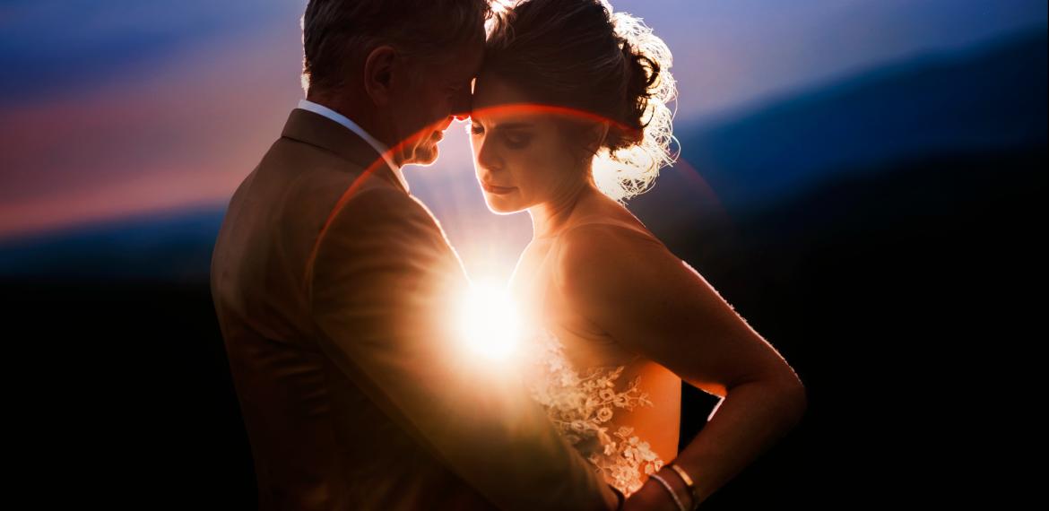 Couple in golden halo with lens flare, Chrisman Studios, destination wedding photographers