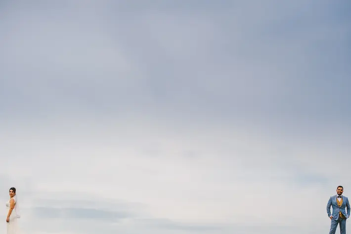 Bride and groom at the opposite ends of the frame - photo by Sam Hurd