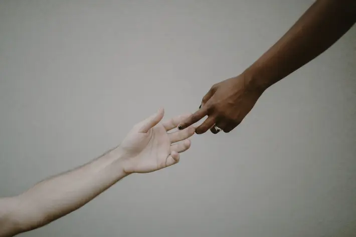 dark and light hands of lovers touching fingers - photo by Kristen Marie Parker