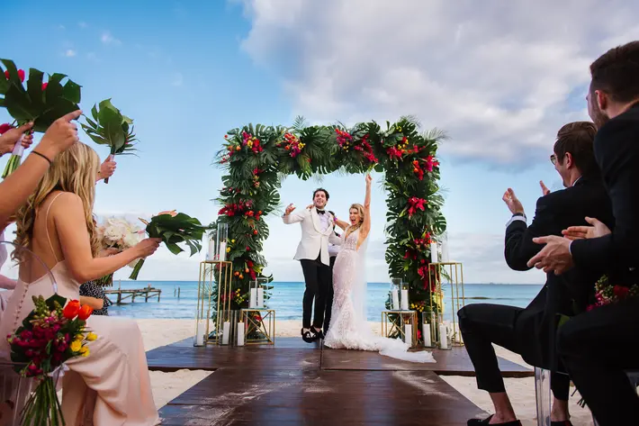 Just married couple celebrate on Cancun beach - photo by Citlalli Rico