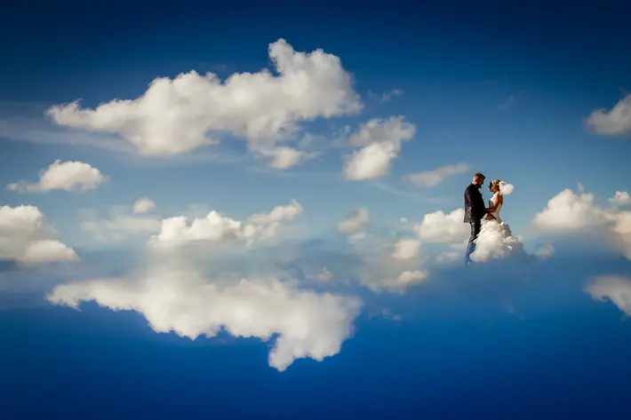 Portrait of couple walking on clouds by Ralf Czogallik - Eppel Photography