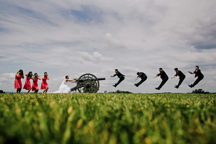 Groomsmen being shot out of a cannon - wedding party portrait by Ken Pak