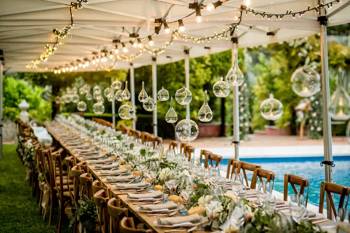 Reception table with hanging glass orbs photographed by Eppel Photography