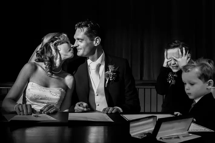Boy shuts his eyes to block couple's kiss - photo by Fotobelle