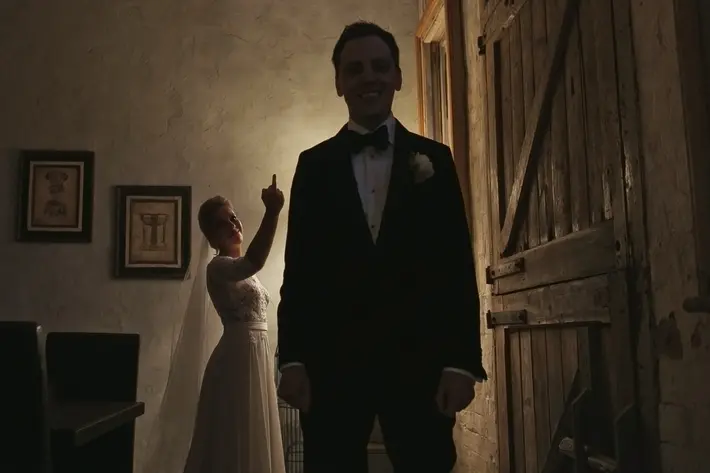 Bride gives her groom the finger before first look - photo by Dan O'Day