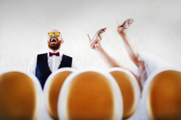 Funny photo of bride falling backward by Victor Lax