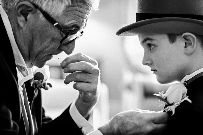 Grandfather pins on grandson's boutonniere - photo by Jeff Ascough