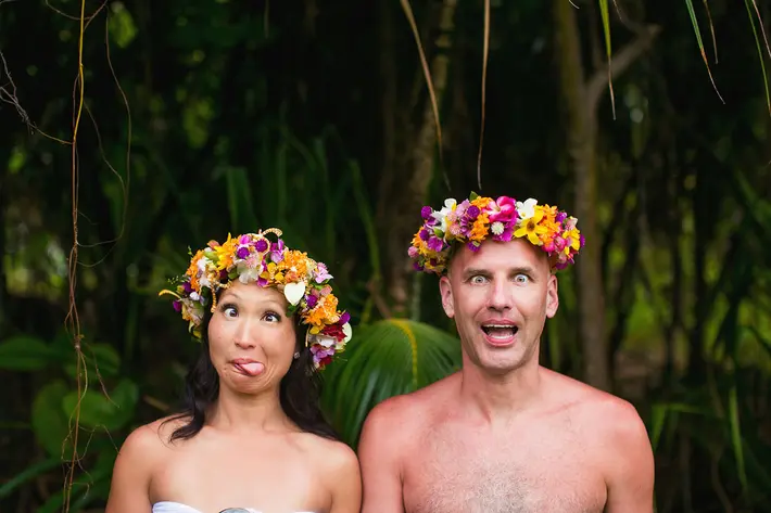 silly-portrait-of-bride-groom-making-faces-with-tropical-wreaths-worlds-best-wedding-photos-callaway-gable-los-angeles-wedding-photographers