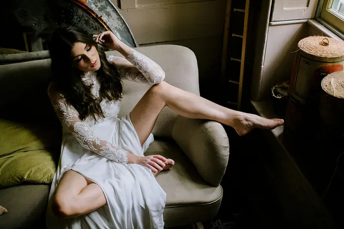 Sultry photo of bride relaxing in her wedding gown by Thierry Joubert