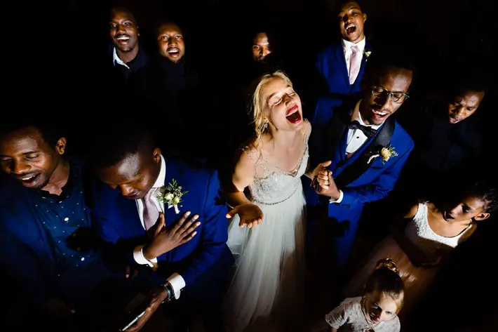 Bride sings with joy surrounded by choir - photo by Jos & Tree - Portland photographers
