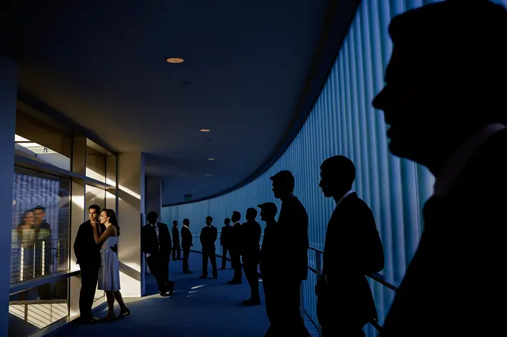 bride-and-groom-pose-next-to-silhouettes-of-men-photo-by-chrisman-studios.jpg 