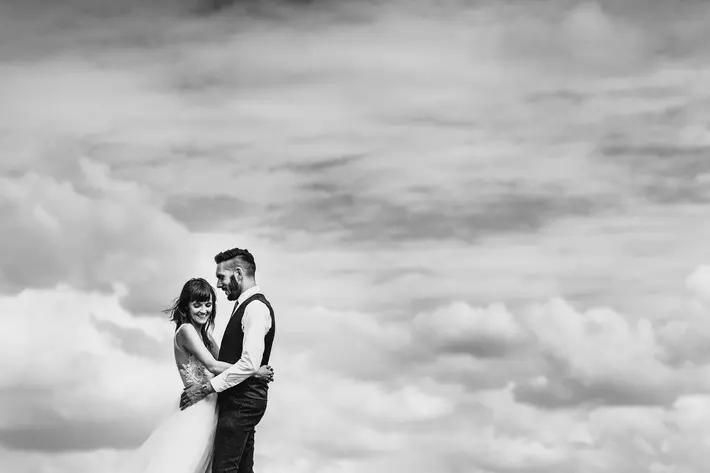 bride-and-groom-pose-against-clouds-photo-by-miki-studios
