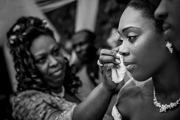 Mother wipes away bride's tears during wedding ceremony - photo by Davina plus Daniel