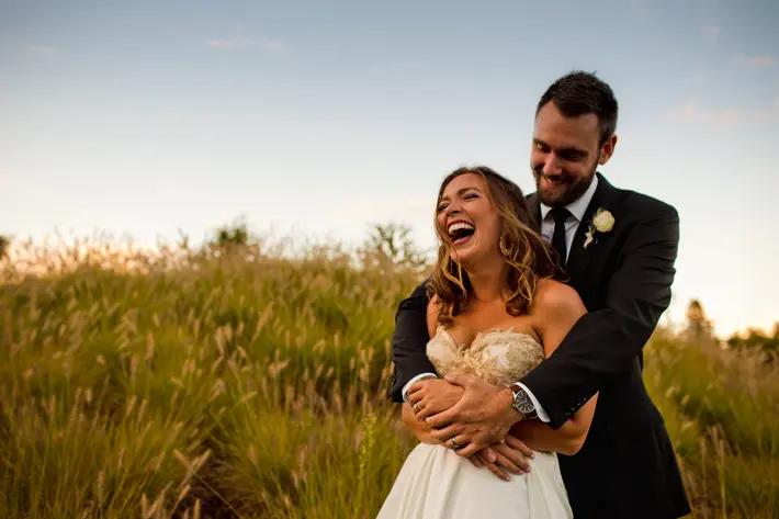Happy couple in grass field near Portland Oregon - photo by Jessica Hill Photography