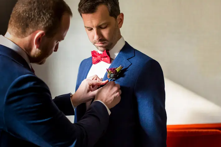 Groom getting thistle boutonniere fastened - photo by Procopio Photography - DC wedding