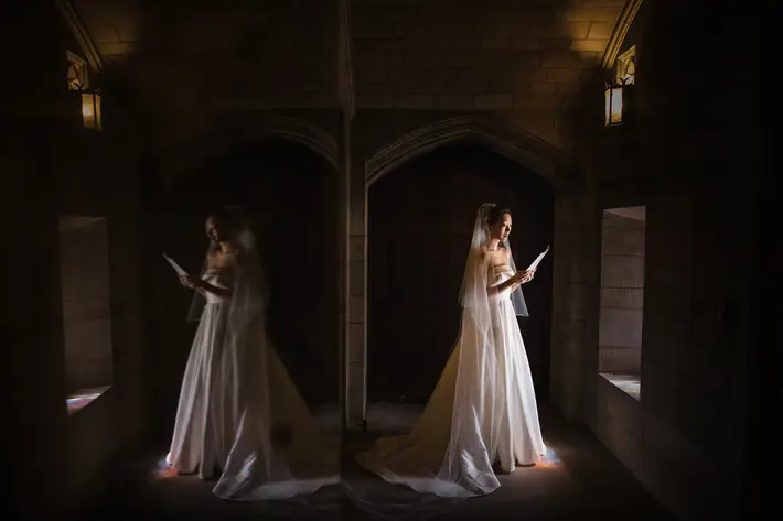 Reflection photo of bride reading her vows in soft windowlight by Susan Stripling - New York wedding photographer