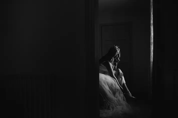 Bride puts on her shoes before wedding - photo by White Cat Studios