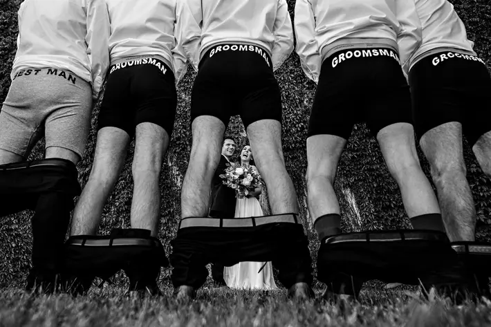 Groomsmen pulls their pants down to show off printed boxers - photo by Moore Photography