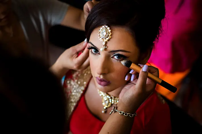 Indian bride having her dramatic make-up applied - photo by Moore Photography - Canada