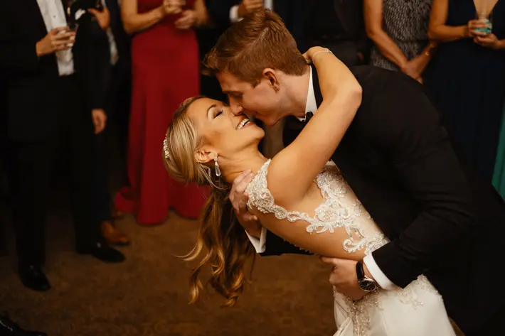 groom-dipping-bride-and-going-in-for-a-kiss-during-their-dance-photo-by-dark-roux