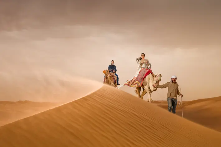 epic-bride-and-groom-portrait-on-camels-on-dunes-eye-jogia-photography